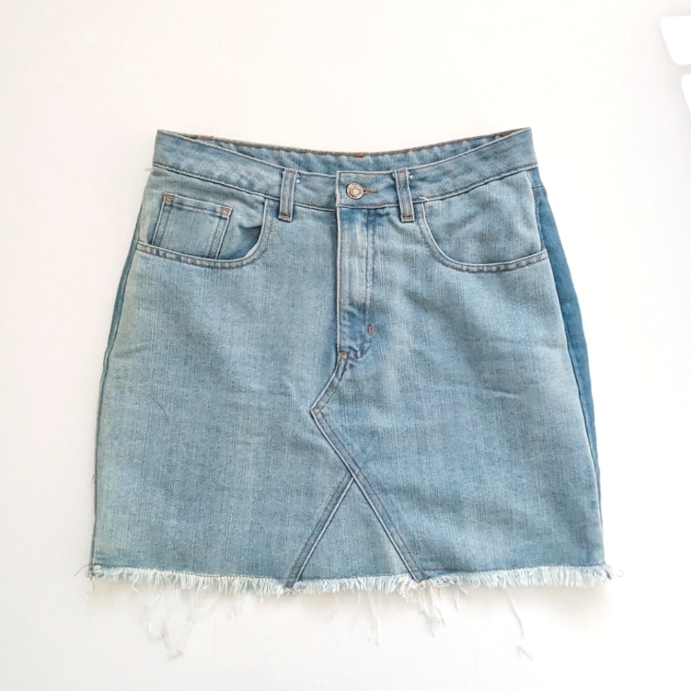 Women's size 28 denim light wash jean skirt with fringe hem.